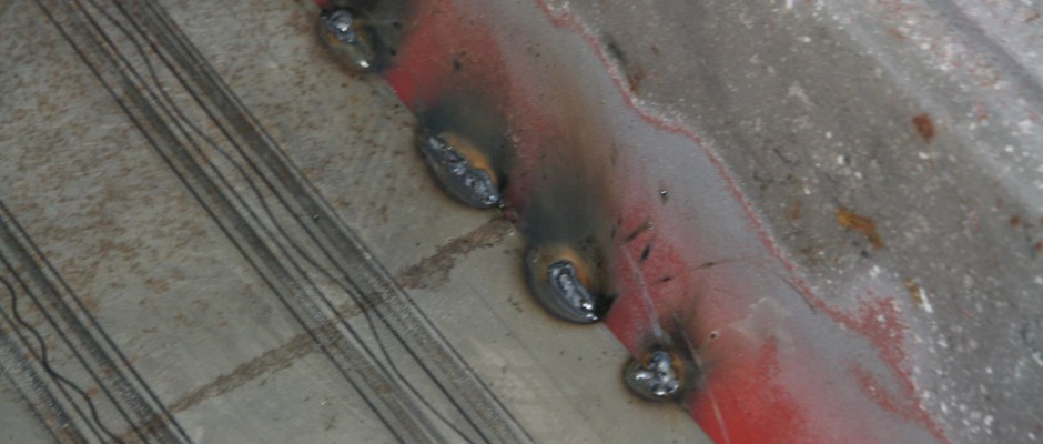 A series of stitch welds were made to secure the panel. By making small spot welds, less heat is put into the metal, which reduces warping and burning through.