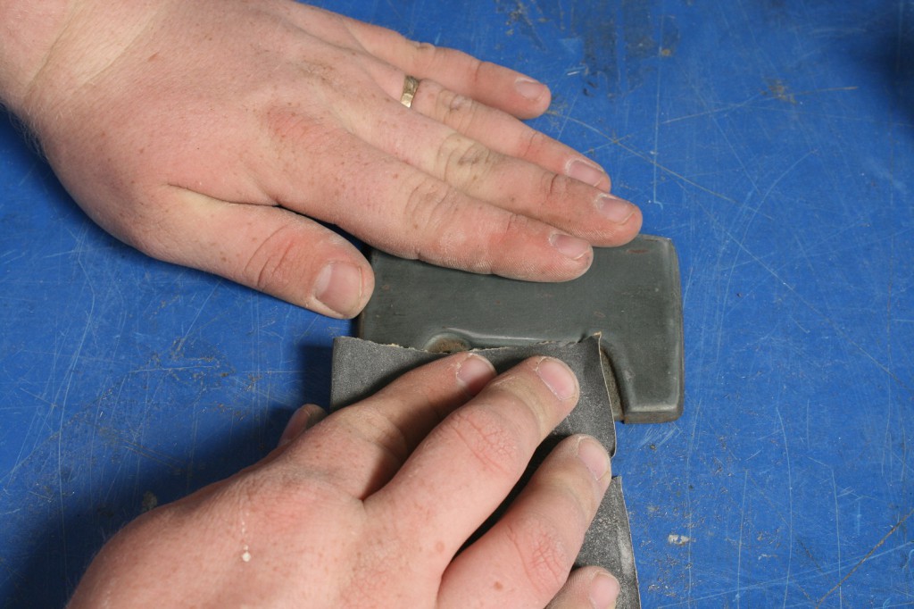 9. We sanded the door down with 200-grit sandpaper, enough to clean and prep the surface without leaving big scratches. This also will feather out any chips.