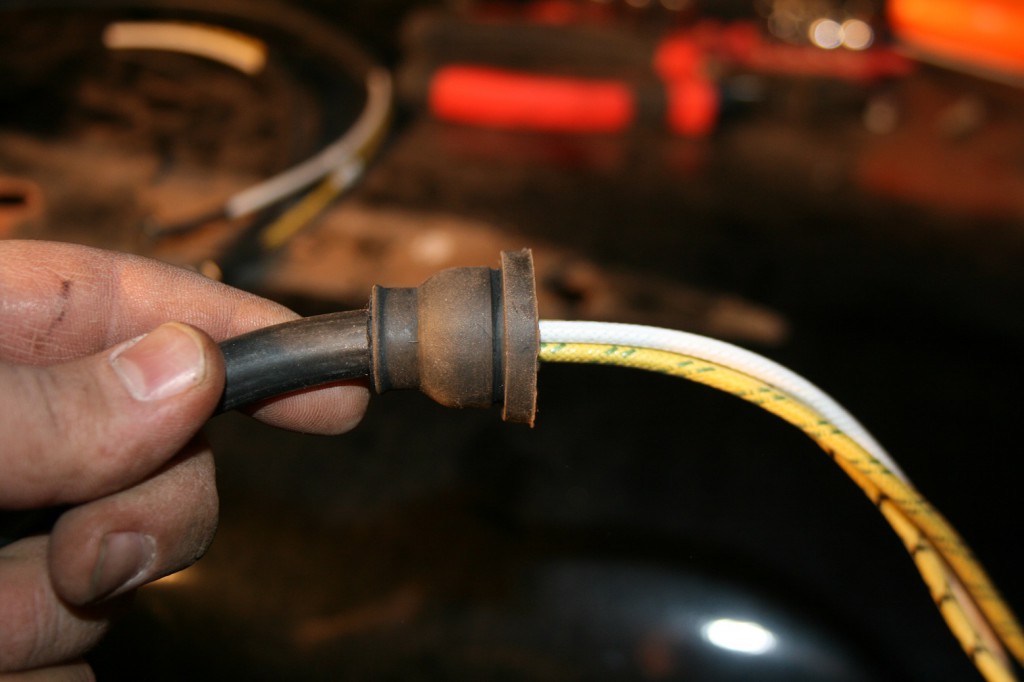18. The headlight harness includes a new rubber plug which requires installation before the wires are run through the fender.