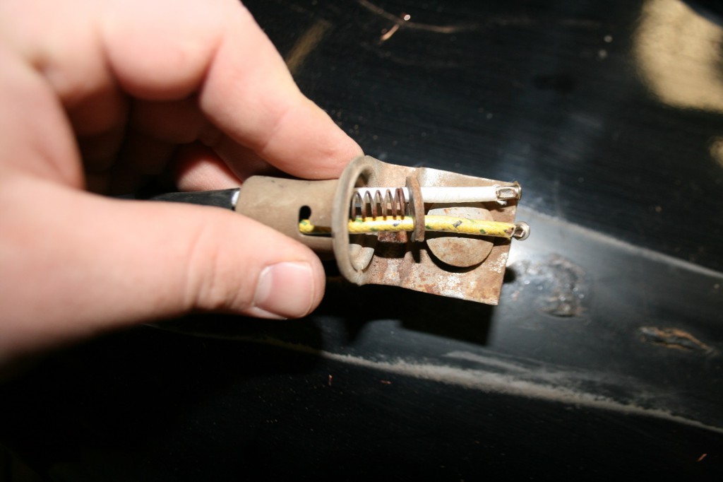 25. Do not forget to slide the wires into the bulb housing BEFORE installing the new terminals. Lay the spring inside and press the wafer board back into position.