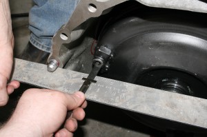 14.The next step is to fill the convertor with a quart of fluid and slide it onto the pump input. The distance from the flat side of the bellhousing to the torque convertor bolt pads, should be in excess of one-inch, otherwise, you won’t have enough clearance for the flexplate. Once clear, bolt it up to the engine and install the 3 flexplate-to-convertor bolts.