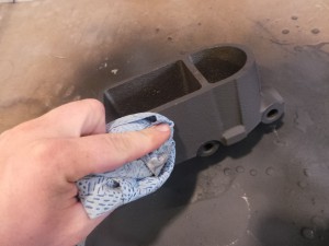17.To get the sheen of cast iron, we used a cloth to buff the surface, bringing out the sheen. Graphite spray is impervious to brake fluid, so it won’t bubble up or peel.