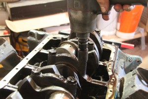 01.We removed the oil pan and started pulling bolts. Before you remove anything, you need to mark each rod cap and rod for position. Use a stamp set and mark only one side with 1-8 respectively. If you flip a rod cap, it won’t line up just right and will ruin your new engine.