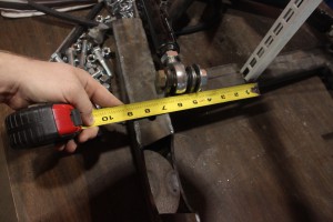 09.Using the precise measurements from Factory Five, the upper control arm crossmember was positioned over the main cradle and tack welded to the temporary support beams (white slotted bar in the upper right)