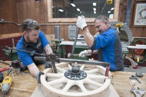After Jonathan drills the felloes and cuts them to the appropriate length, it’s time for some muscle, as the felloes are stretched to fit the spoke array. This requires brute force, and in this case, a modified bumper jack, a huge pry bar and a hammer.