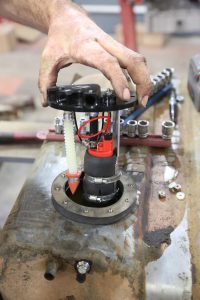 A foam pad goes onto the top of the studs and then the pump housing drops into the tank. Be careful not to pinch the wires.